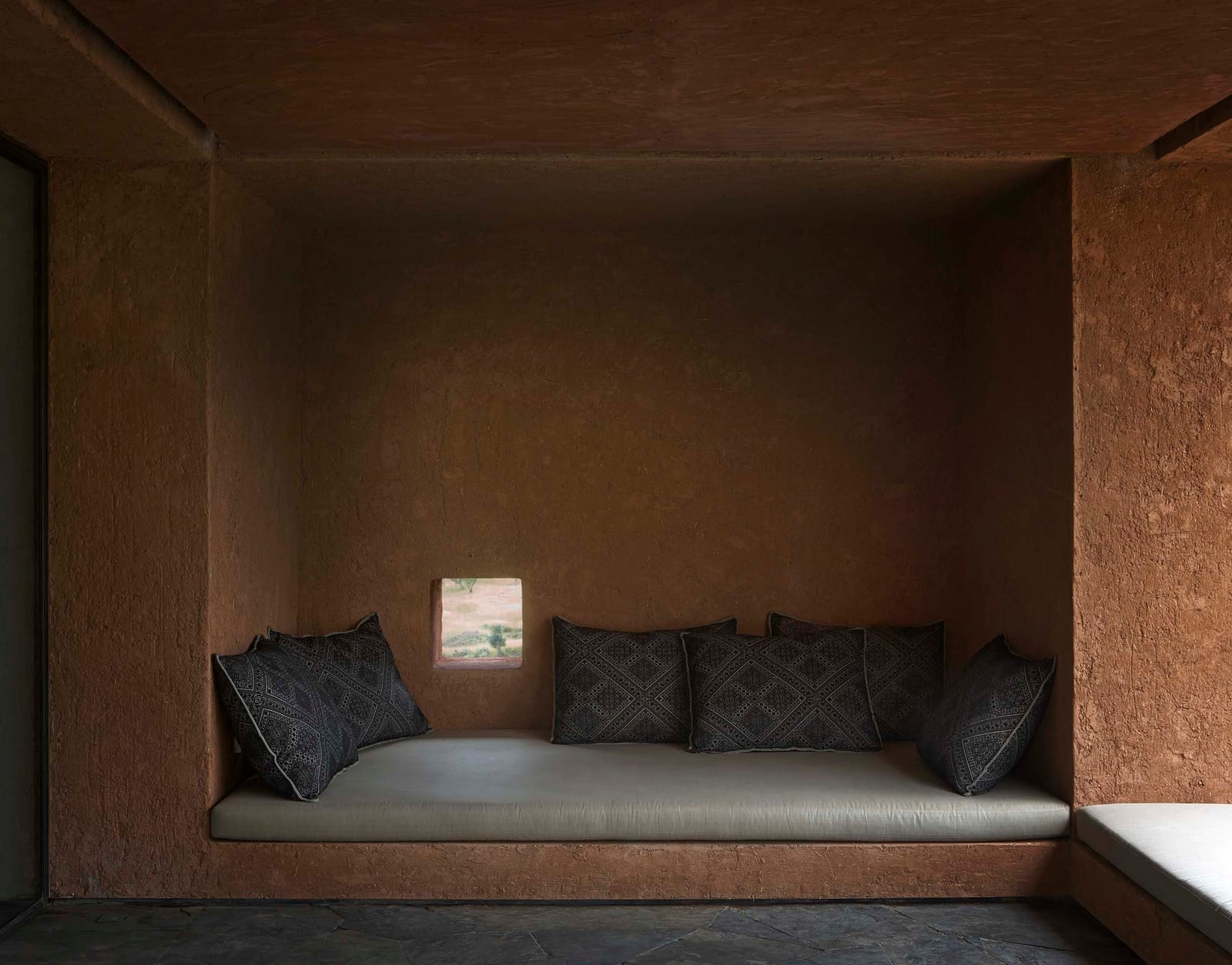 Terracotta-lined alcove with a built-in banquette, Villa E
