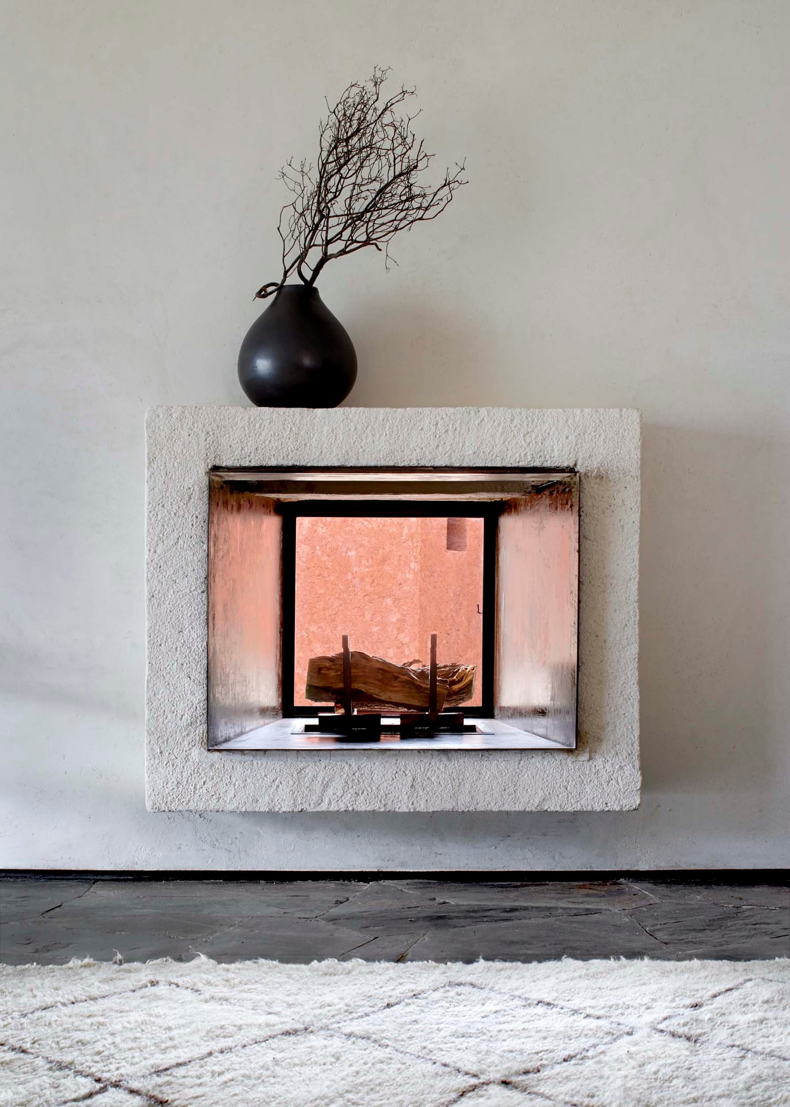 Plastered fireplace and black vase, Villa E